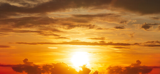 The Brightness sunrise and clouds on orange sky, nature golden hour panorama picture.
