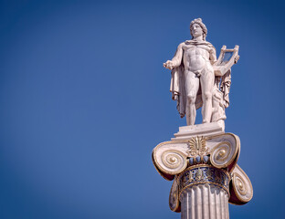 Apollo the ancient Greek god of poetry and music under blue sky with space for your text, Athens Greece