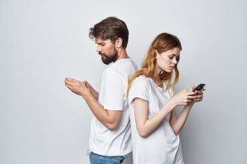 married couple family with phones in hand communication studio lifestyle