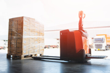 Electric Forklift Pallet Jack with Package Boxes Wrapped Plastic Film on Pallet. Cargo Shipment Boxes Warehouse Logistics and Transportation.	