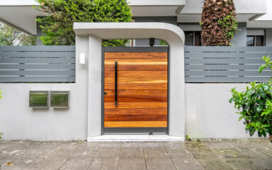 contemporary house front entrance natural wood door by the sidewalk, Athens Greece