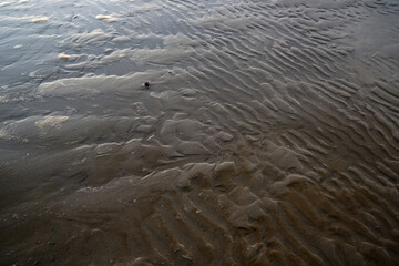 Sand wave pattern on the beach, abstract nature background