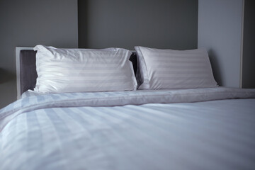 Clean White  pillows and blanket on the bed
