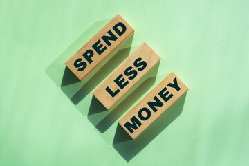 Spend Less Money on wooden blocks, Financial concept. Selective focus.