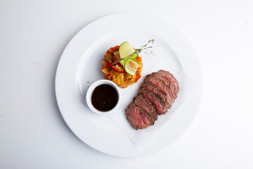 Sliced ​​barbecue meat with rice and red sauce