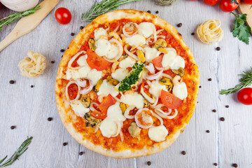 italian pizza on a wooden background with decoration around