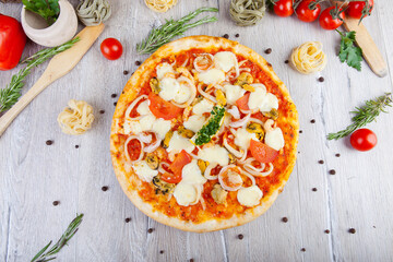 italian pizza on a wooden background with decoration around