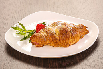 Sweet croissant in the plate
