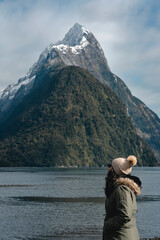 Woman looking at beautiful famous fjord in Milford Sound. New Zealand