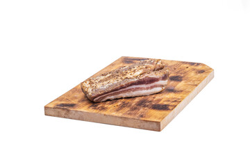 wooden board in retro style. a piece of bacon is cut into pieces on it. on a white background. close-up.