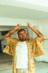 portrait of gay dark skinned indian man in abandoned building