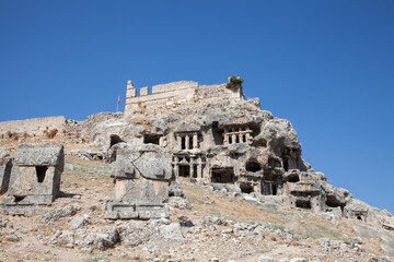 Fototapeta na wymiar Tlos, Ruins of the ancient town over blue sky near the city of Fethiye, Mugla province, Turkey.