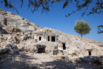 Lycian rock tombs over blue sky at location Tlos Ancient City, Turkey