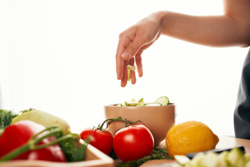 slicing fresh vegetables ingredients for salad healthy food in the kitchen