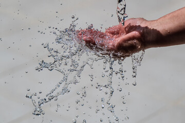 Fototapeta premium Human hand with water splashing on it