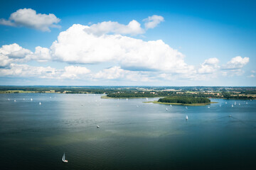 Aerial view of green islands and clouds at summer sunny day. Masurian Lake District in Poland. 