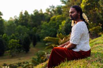 portrait of dark skinned Indian non-binary individual with traditional female attire in park