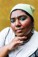 dark skinned Indian non-binary individual smiling in park