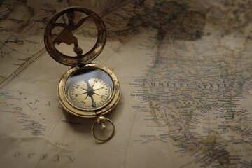 Retro style antique golden compass (sundial) and old nautical chart close-up. Vintage still life. Sailing accessories. Wanderlust, travel and navigation theme. Graphic resources, copy space - 461970786