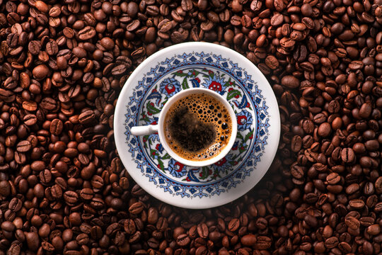 Arabic coffee cup with roasted beans © dimasobko
