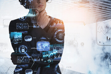 Businessman hand on chin, hologram of blue glowing digital information security interface. Concept of cyber security and data storage. Fingerprint and business charts. Low angle skyscraper faзades