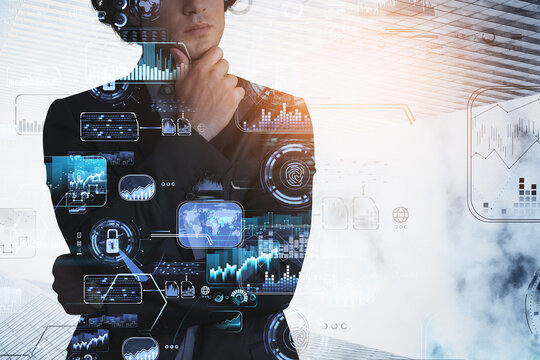 Businessman hand on chin, hologram of blue glowing digital information security interface. Concept of cyber security and data storage. Fingerprint and business charts. Low angle skyscraper faзades - Powered by Adobe