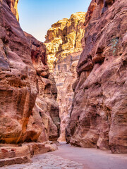 Fototapeta na wymiar Picture with al-Siq, the natural passage through red rock walls which is main entrance to the ancient Nabatean city of Petra in southern Jordan.