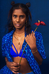portrait of dark skinned Indian woman from Malaysia against dark blue background