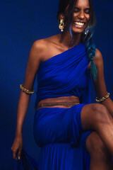 portrait of dark skinned Indian woman from Malaysia against a dark blue background