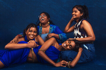 group portraits of dark skinned Indian women from Malaysia against a dark blue background