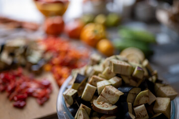 on kitchen table there are chopped vegetables ready to cook