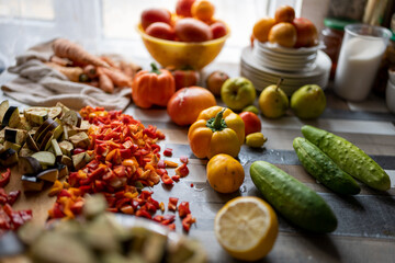on kitchen table there are chopped vegetables ready to cook