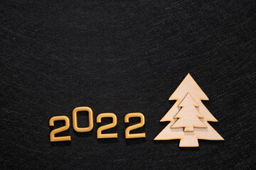 gold numbers 2022 with wooden fir tree