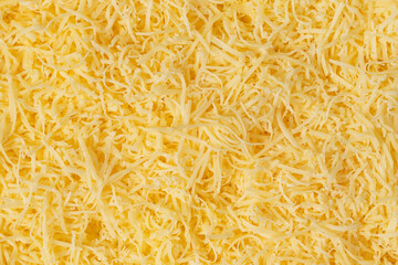 Grated cheese background texture. yellow shredded  cheese. Close up top view.