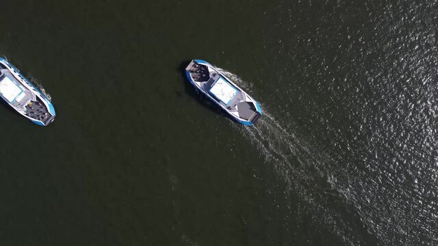 Aerial Top Down View Of Amsterdam Ferries Passing Eachother They Provide Essential Free Connections Across The River IJ For Pedestrians Cyclists And Mopeds 4k High Quality Resolution Footage