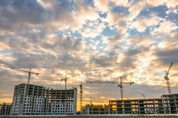 Construction Cranes and Sunset Clouds