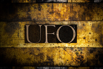 UFO text on textured grunge copper and vintage gold background