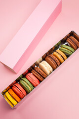 delicious macaroons on pastel color background