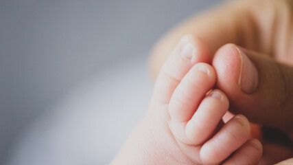 Macro shot of infants toe. Mother touching her small child's toes while he is asleep. Slow motion Video of mother touching her sons feet. Mum cares of her infant baby. 