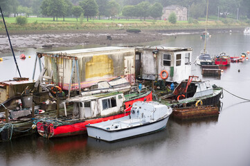 Fototapeta na wymiar Old boats derelict on River Leven in Dumbarton