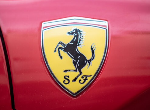 Ferrari Logo, Yellow Shield With Italian Tricolor And Black Prancing Horse, Red Background