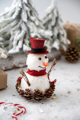 Snowman Christmas decoration with gift boxes and fir tree on white background.