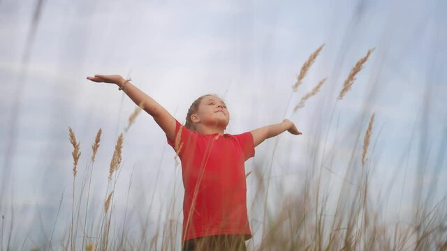 kid pray. pulls hands against a sky. child girl concept faith religion and happy family. kid girl pray hands to the side against sky jew kid praying to god. worship and gratitude religion lifestyle