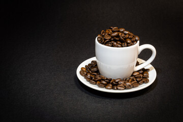 white espresso cup filled with coffee beans