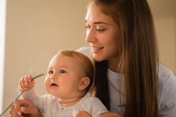 Helping her baby with the fork