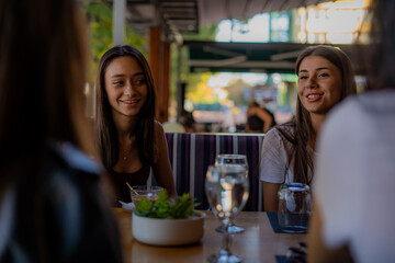 Talking while laughing about their talk