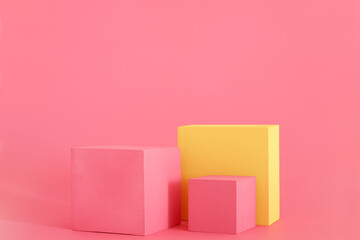 Pink and yellow podium on the pink background. Podium for product, cosmetic presentation. Creative mock up. Pedestal or platform for beauty products.