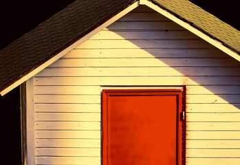 A small hut with a red door