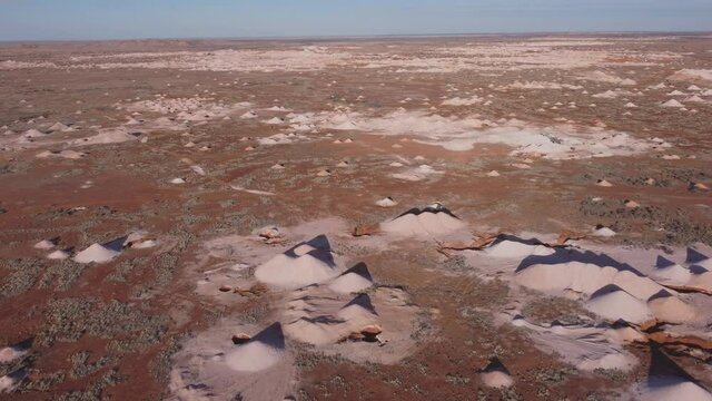 an aerial shot flying forward over opal mines and mullock heaps at coober pedy in outback south australia