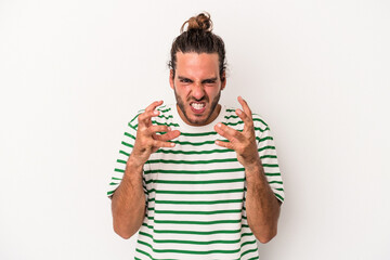 Young caucasian man isolated on white background upset screaming with tense hands.